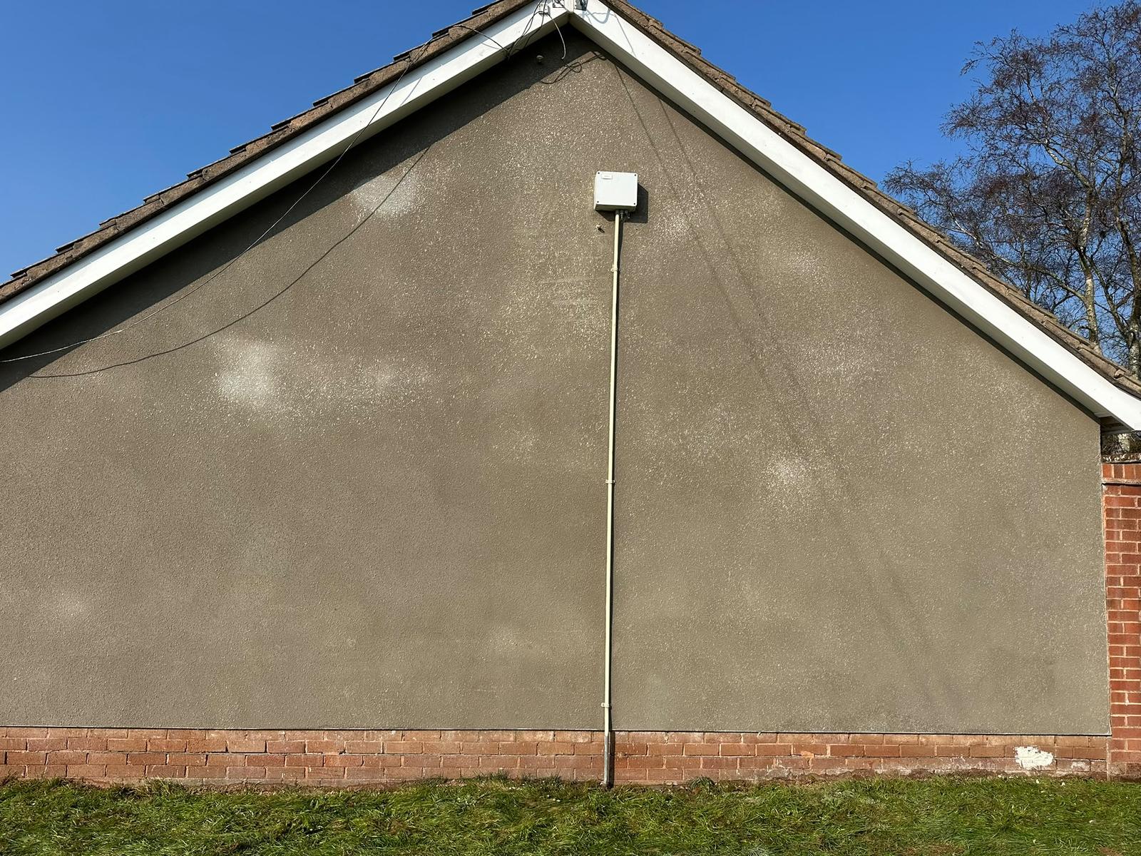 After: bungalow gable re-rendered with a Terraline finish, Devon