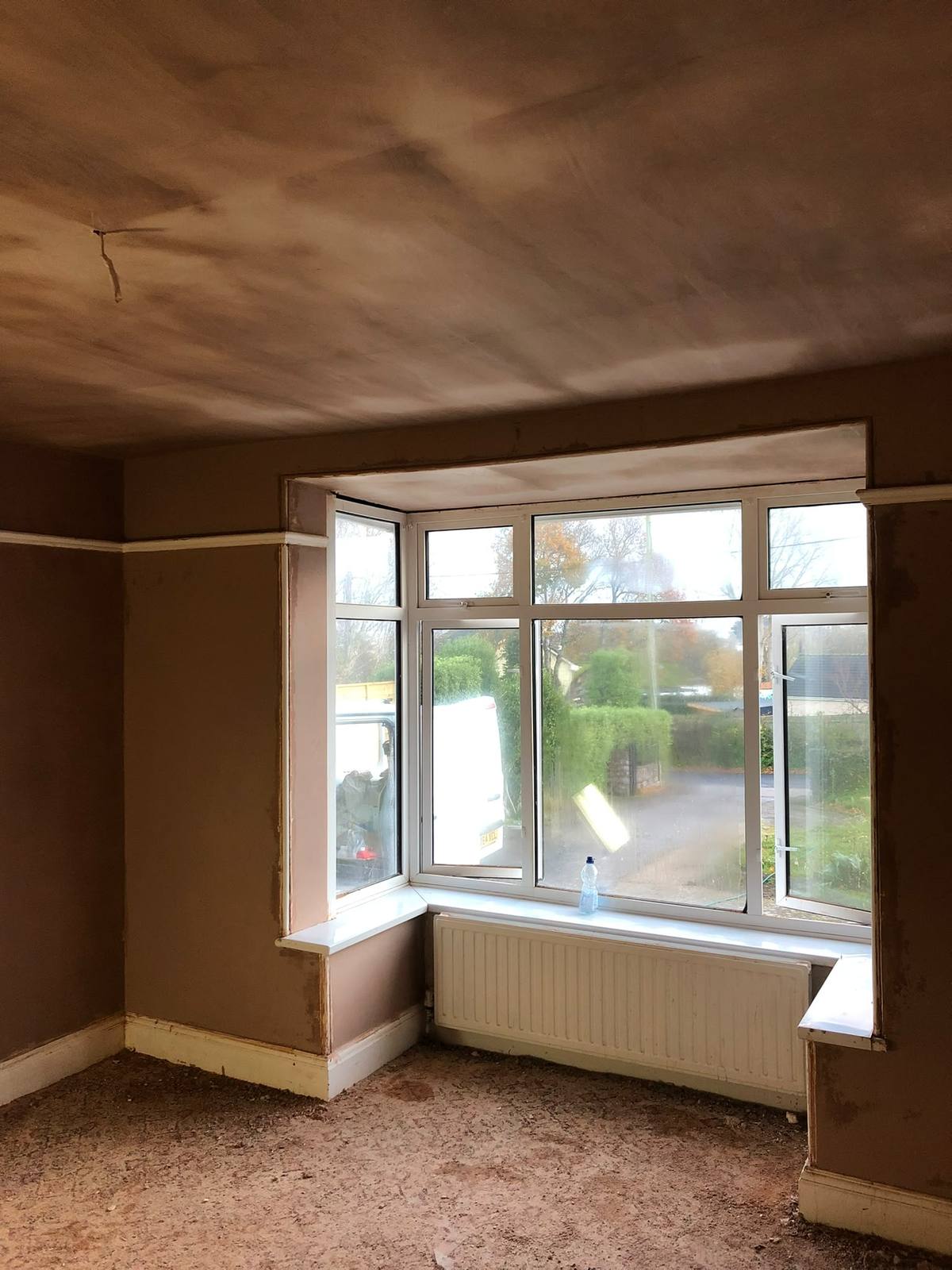 Bay window room with walls and ceiling skimmed in Exeter