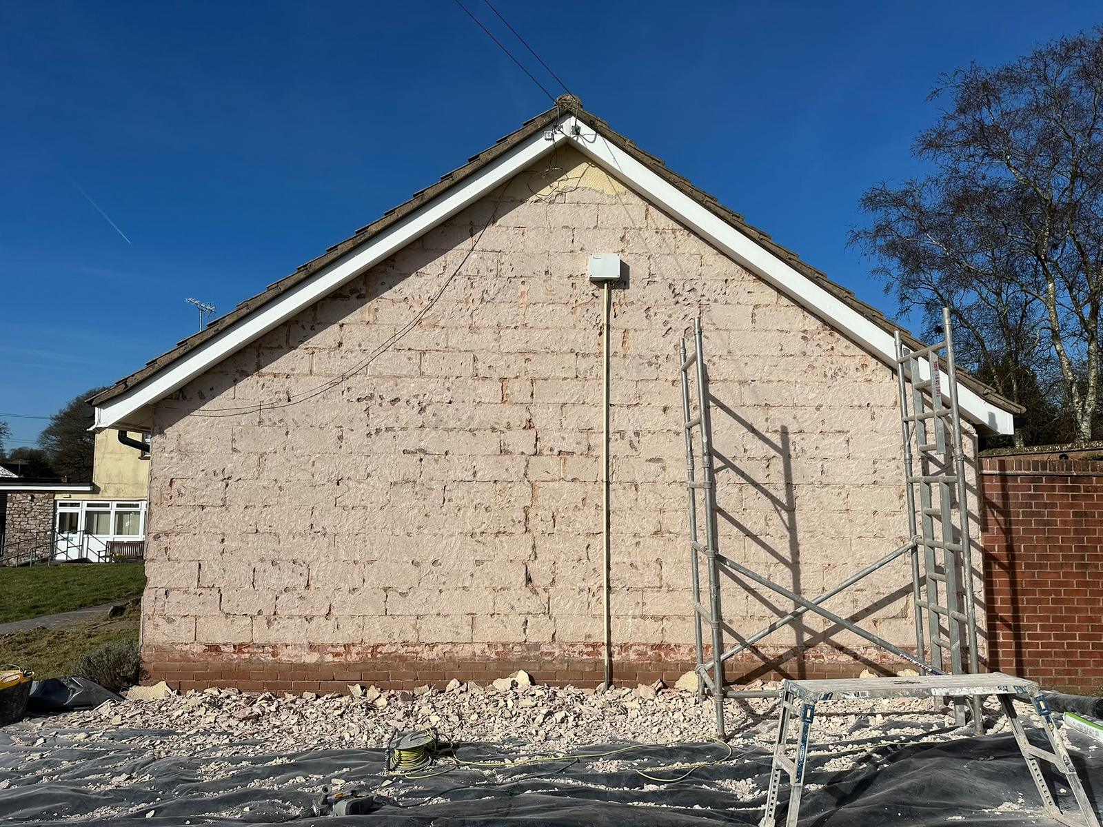 Before: blown sand and cement render hacked off a bungalow gable back to blockwork