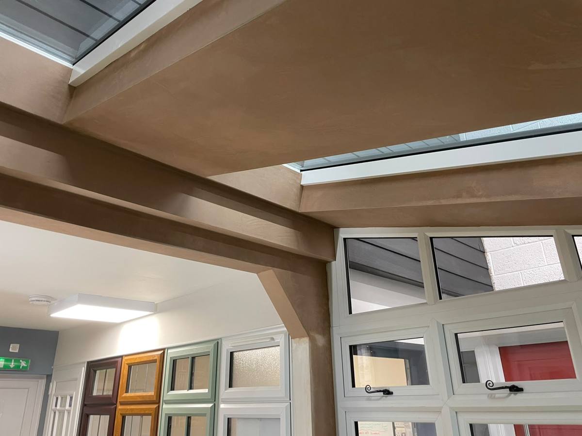 Large room with boxed beam and ceiling skimmed