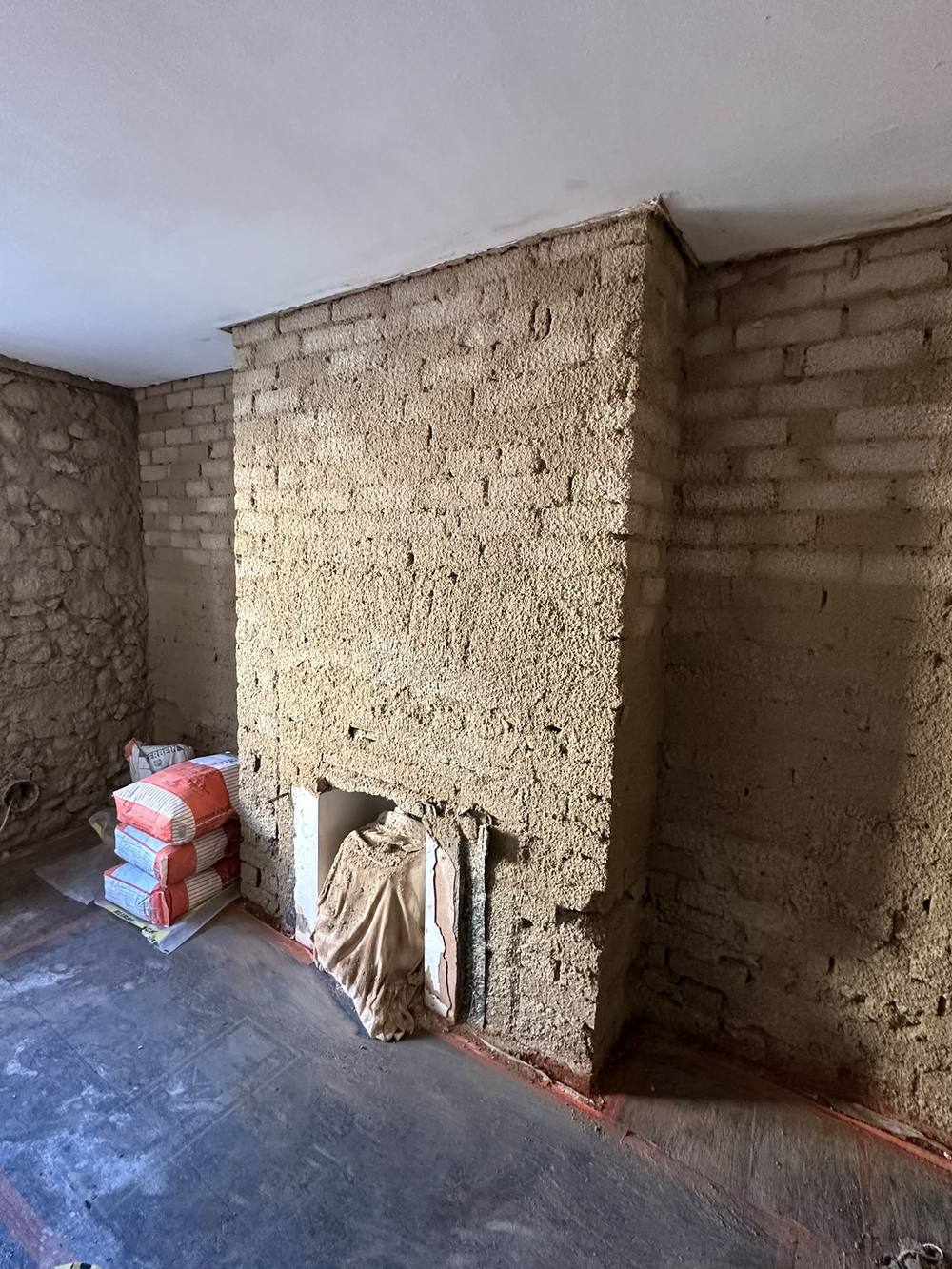 Lime harl and scratch coat applied to a chimney breast