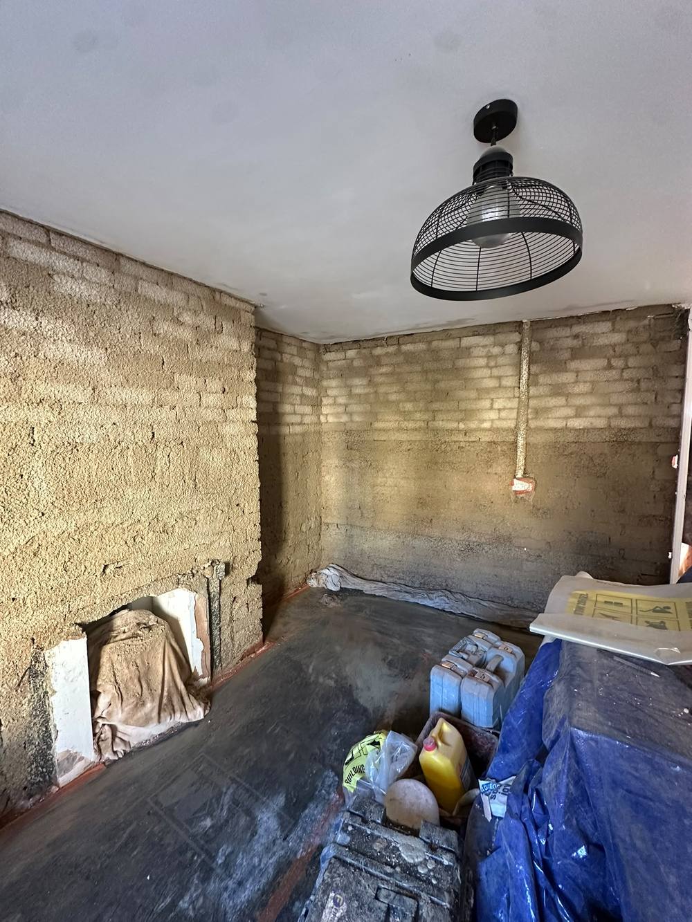 Lime scratch coats curing on cob and stone walls