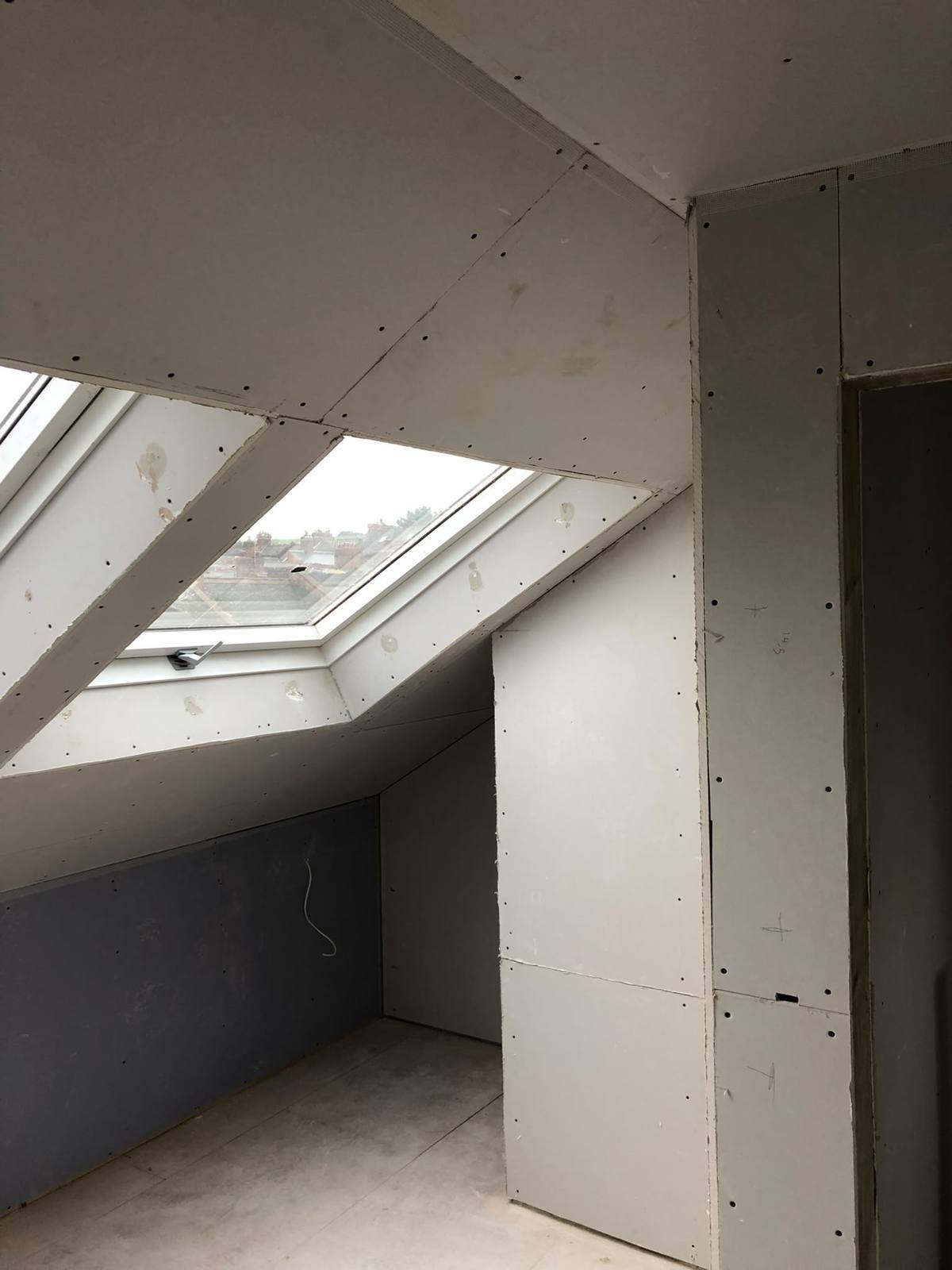 Loft skylight reveals and knee walls boarded around fitted wardrobes