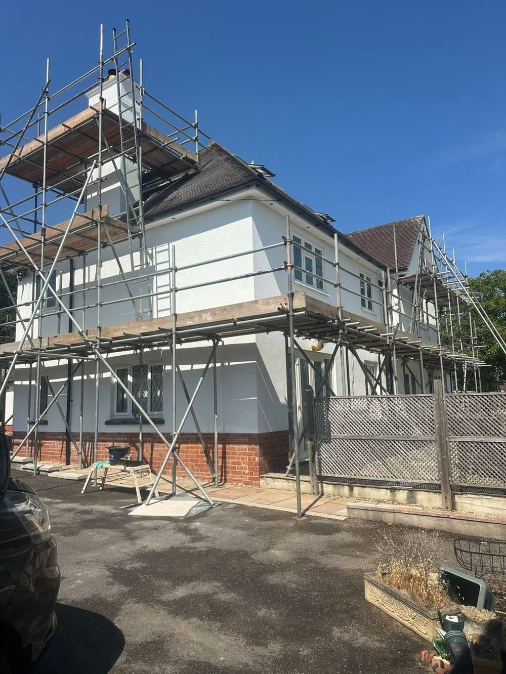 White silicone render in progress on scaffolding in Cowley, Devon